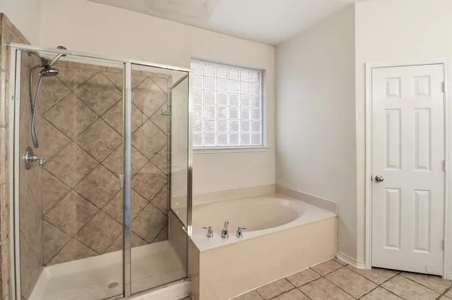 a bathroom with a bathtub and shower