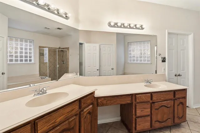 a bathroom with a sink double vanity and a mirror