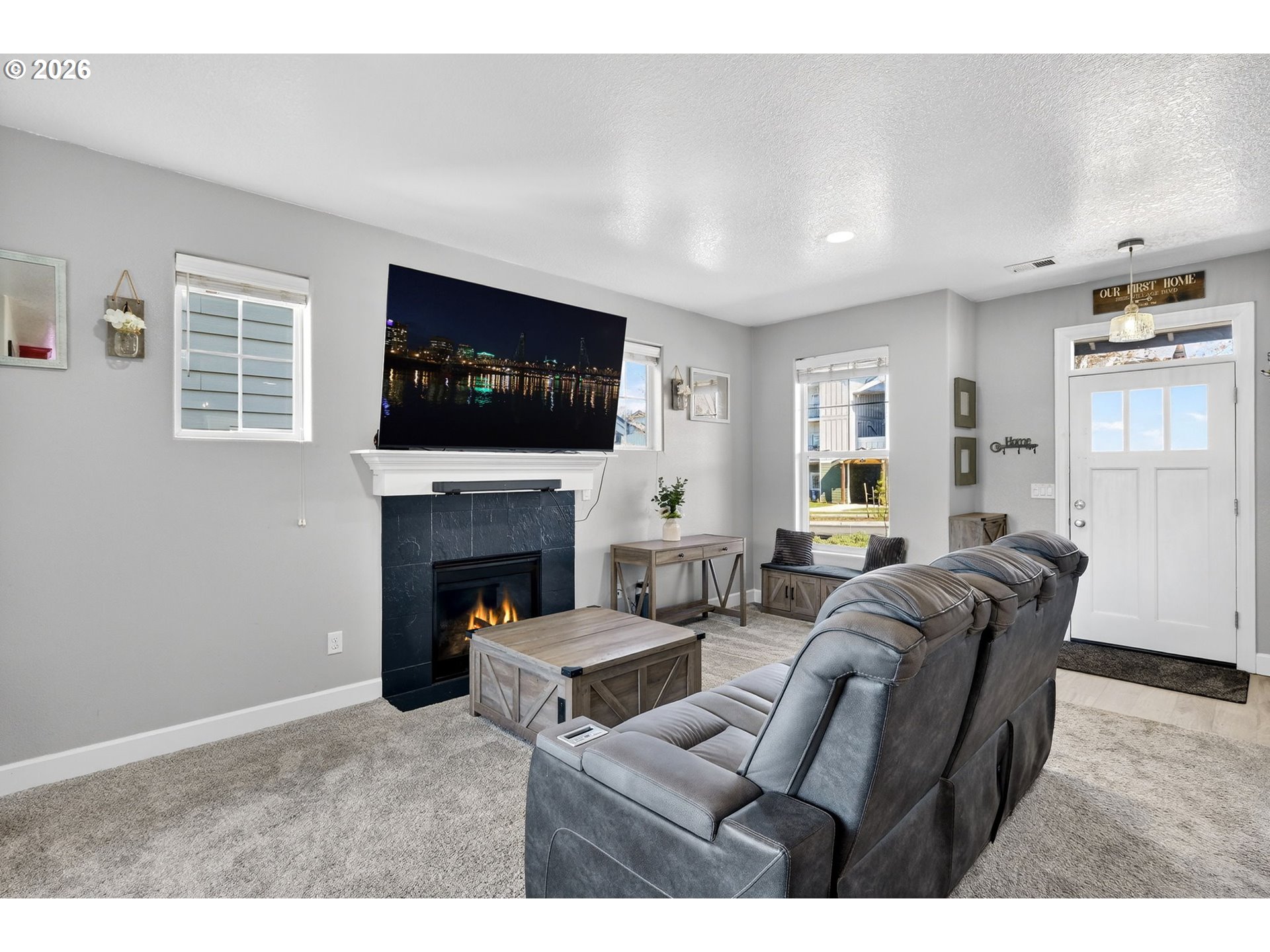 19135 Southeast Village Boulevard Sandy, OR 97055 - Photo 11 of 43 a living room with furniture a fireplace and a flat screen tv