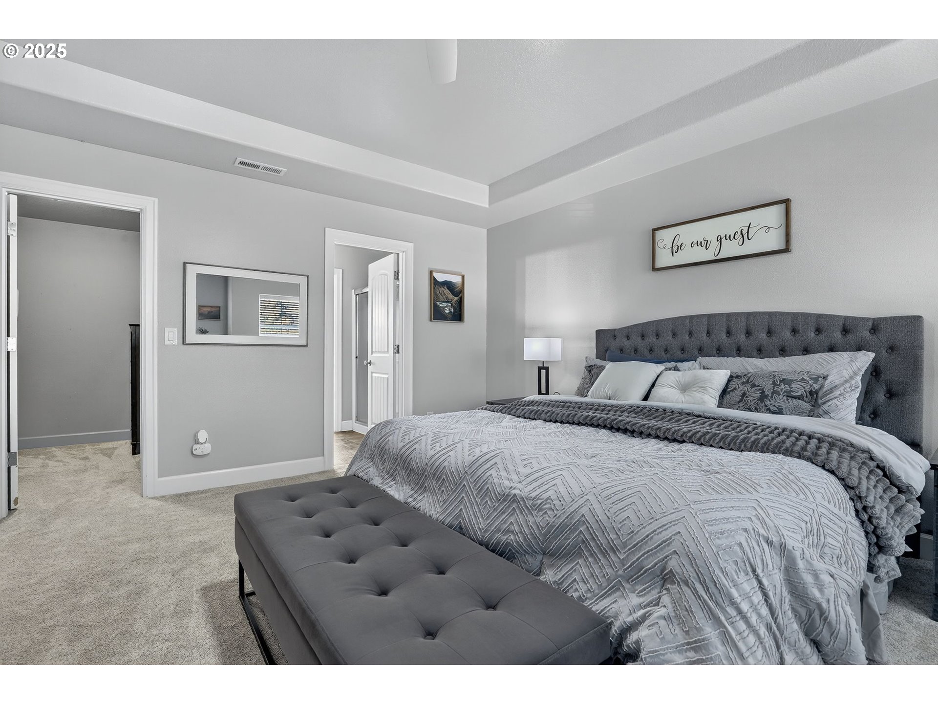 19135 Southeast Village Boulevard Sandy, OR 97055 - Photo 22 of 43 a bedroom with a large bed and a view of bathroom