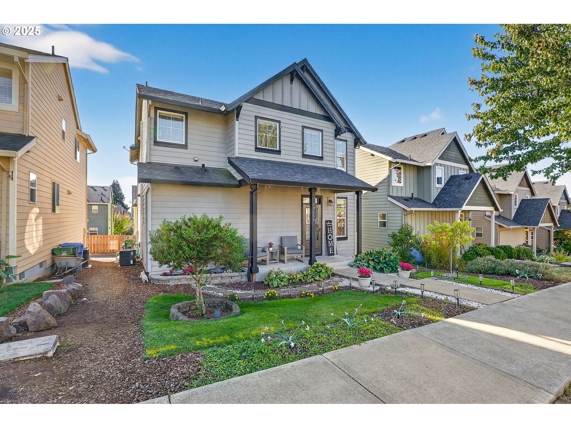 19135 Southeast Village Boulevard Sandy, OR 97055 - Photo 3 of 43 a front view of a house with garden