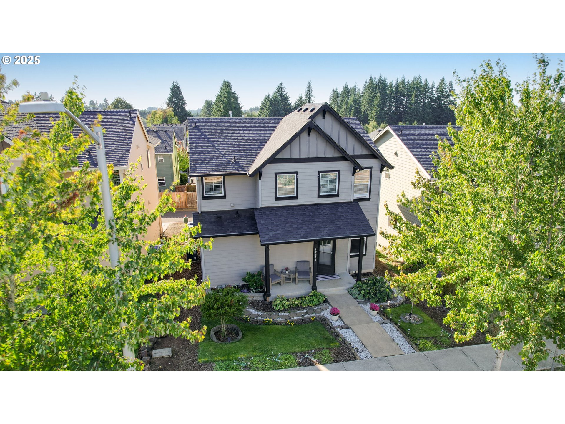 19135 Southeast Village Boulevard Sandy, OR 97055 - Photo 31 of 43 a view of a house with a yard and potted plants