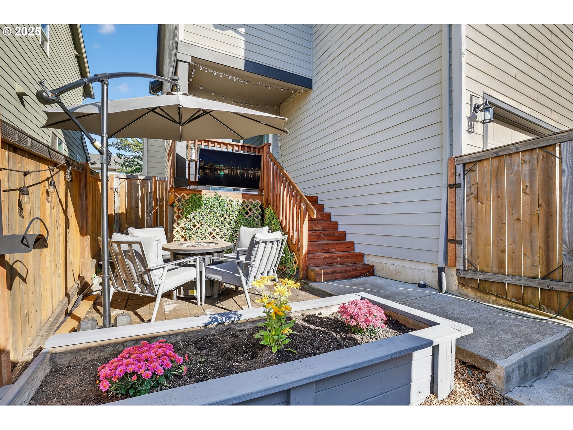 19135 Southeast Village Boulevard Sandy, OR 97055 - Photo 38 of 43 a view of a patio with table and chairs under an umbrella