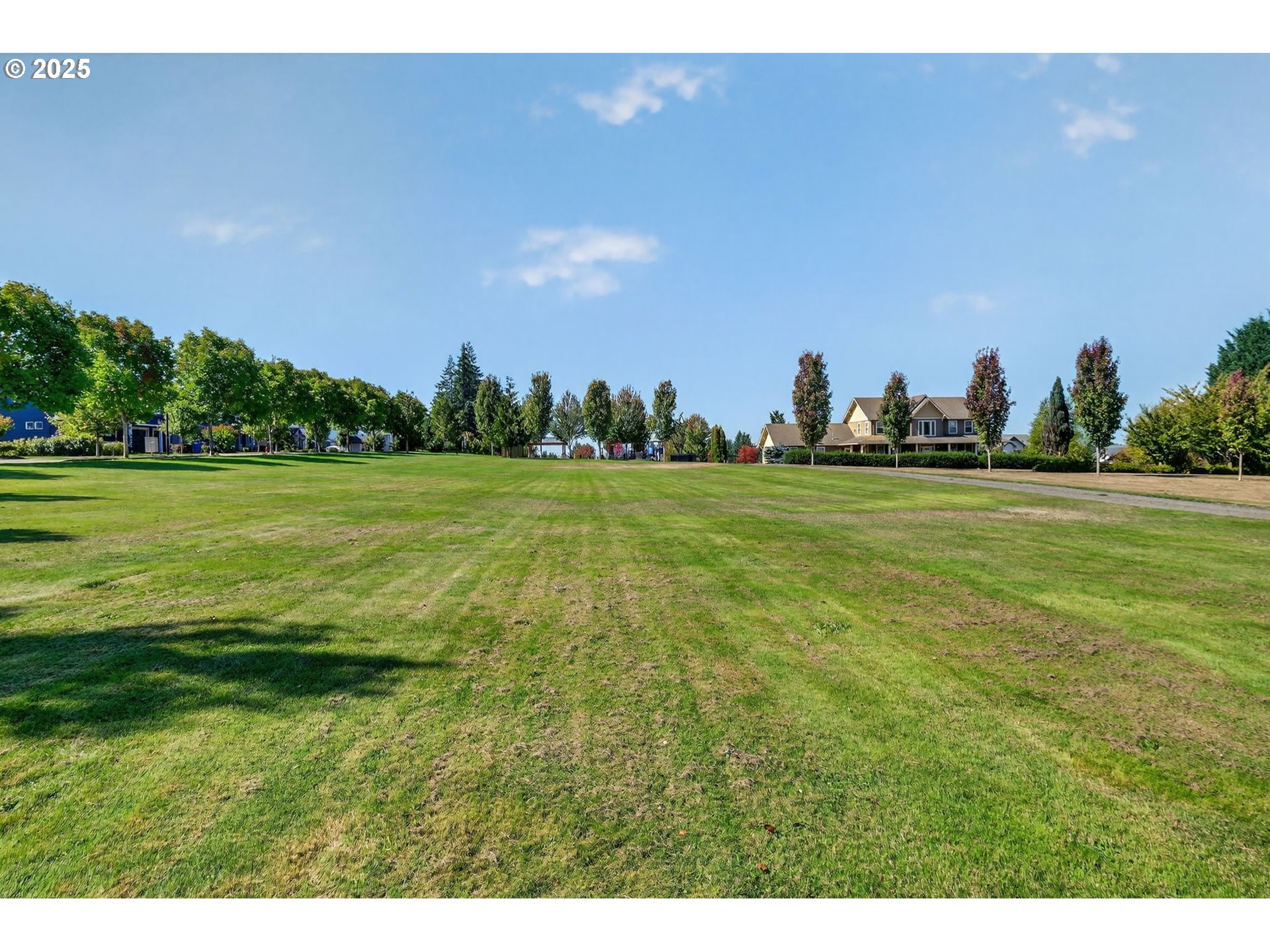19135 Southeast Village Boulevard Sandy, OR 97055 - Photo 39 of 43 a view of a big yard with a house in the background