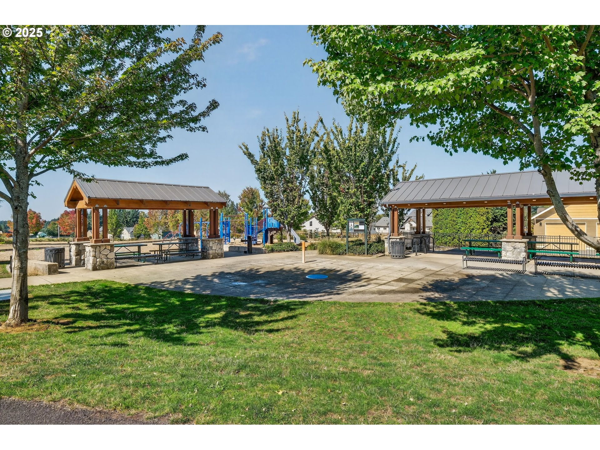 19135 Southeast Village Boulevard Sandy, OR 97055 - Photo 40 of 43 a view of patio with a table and chairs under an umbrella
