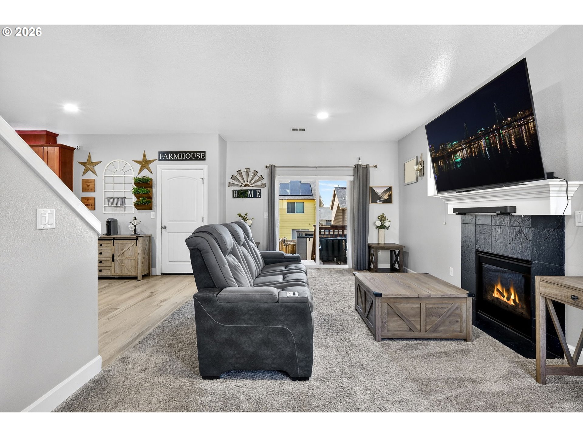 19135 Southeast Village Boulevard Sandy, OR 97055 - Photo 8 of 43 a living room with furniture a flat screen tv and a fireplace