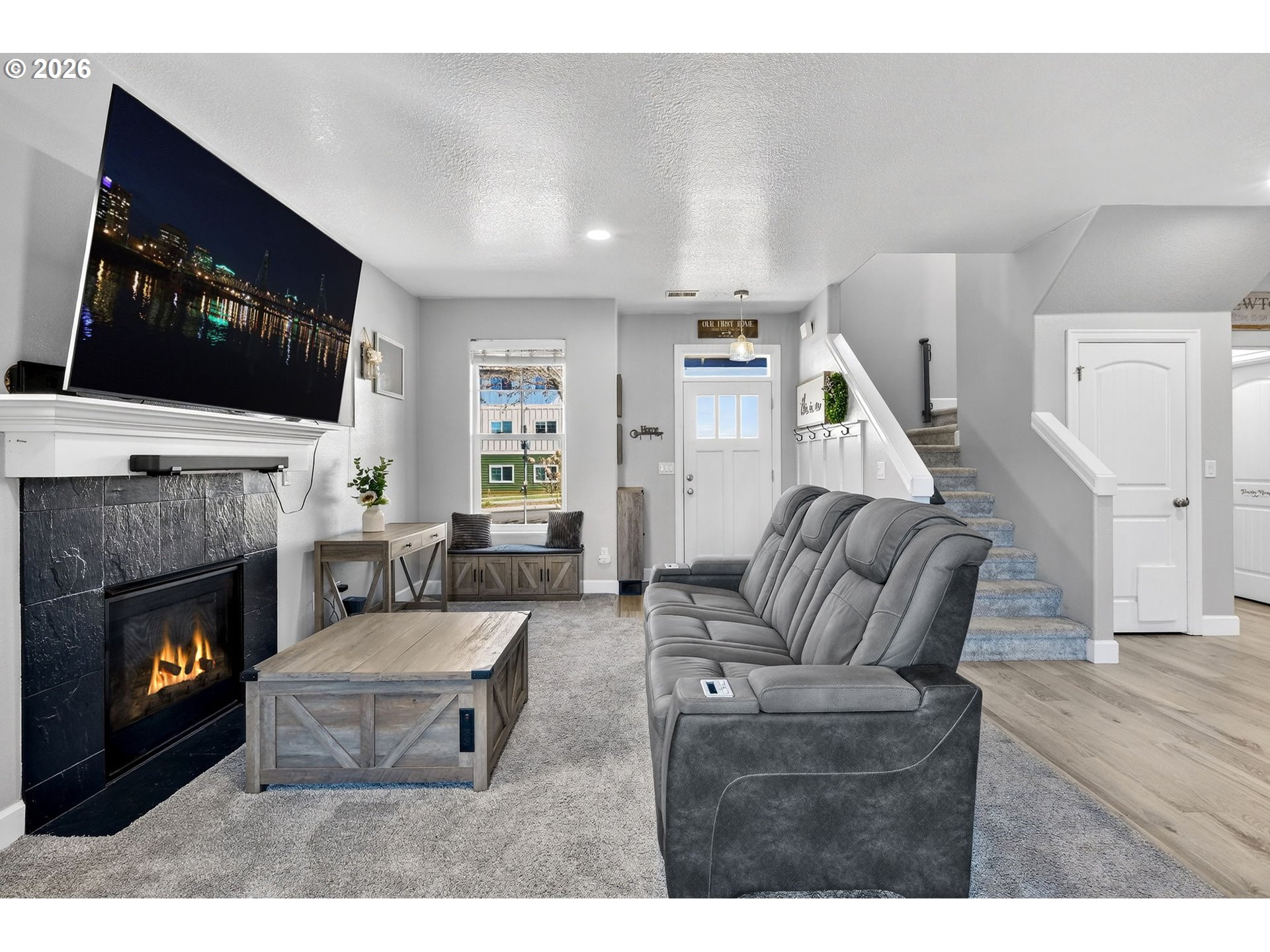 19135 Southeast Village Boulevard Sandy, OR 97055 - Photo 9 of 43 a living room with furniture a flat screen tv and a fireplace