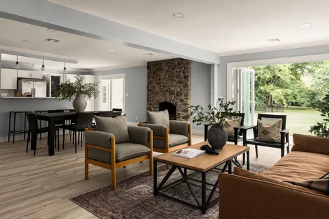 a living room with furniture wooden floor and a fireplace