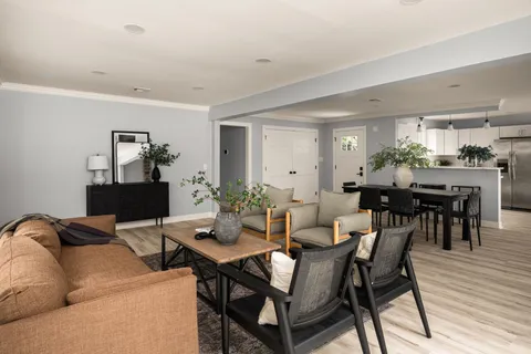 a view of a dining room with furniture and wooden floor