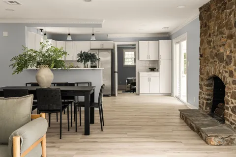 a dining room with furniture and wooden floor