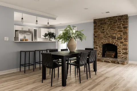 a dining room with furniture and wooden floor
