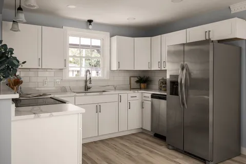 a kitchen with a refrigerator sink and cabinets