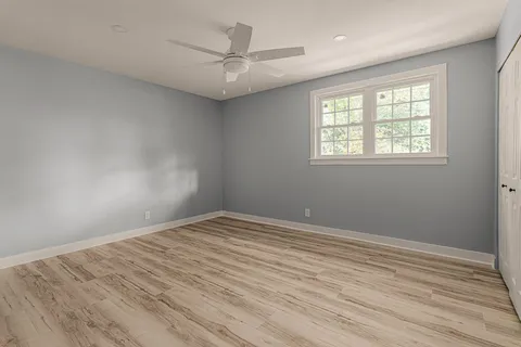 wooden floor in an empty room with a window