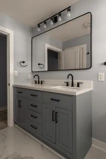 a bathroom with a double vanity sink and mirror