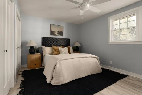 a bedroom with a bed and wooden floor
