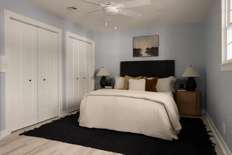 a bedroom with a bed and a painting on the wall