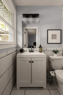 a bathroom with a toilet sink and mirror
