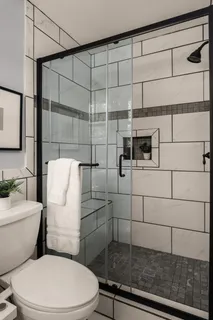 a bathroom with a toilet and a shower