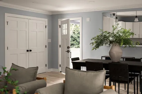 a living room with furniture and a potted plant