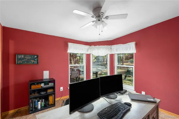a view of workspace with wooden floor and windows