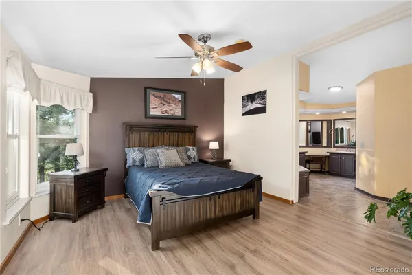 a living room with a bed furniture and a large window