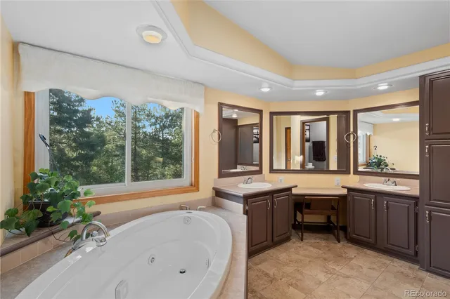 a large bathroom with a tub and sink