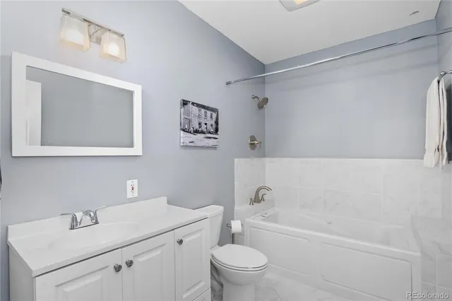 a bathroom with a sink toilet and vanity