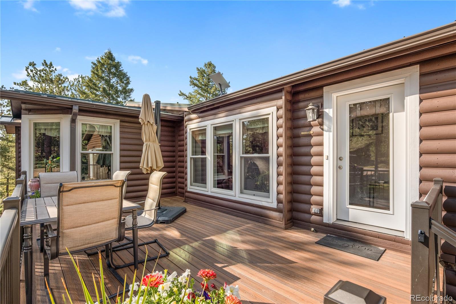 20065 Spring Creek Road Buffalo Creek, CO 80425 - Photo 3 of 41 a view of a patio with table and chairs and potted plants