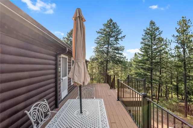 a view of a balcony with wooden floor and fence