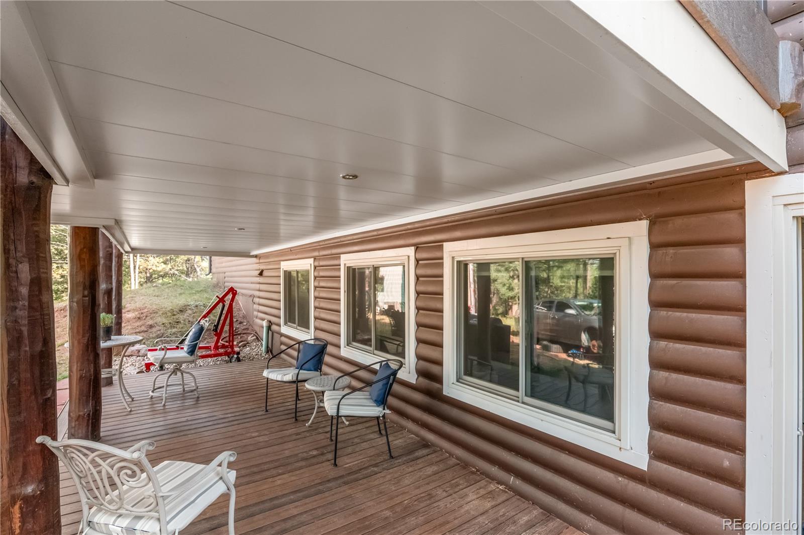 20065 Spring Creek Road Buffalo Creek, CO 80425 - Photo 33 of 41 a living room with furniture and a floor to ceiling window