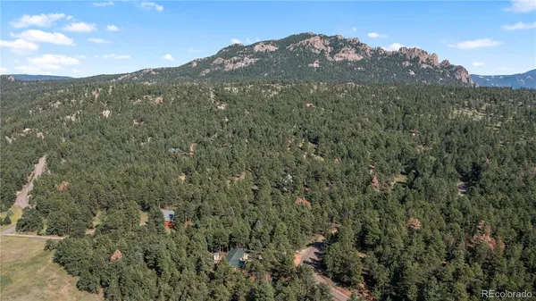 a view of a large mountain with mountains in the background