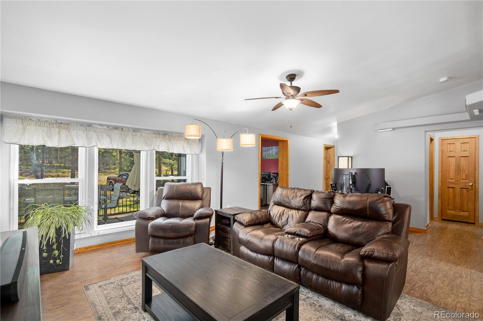 20065 Spring Creek Road Buffalo Creek, CO 80425 - Photo 8 of 41 a living room with furniture and a large window with garden view