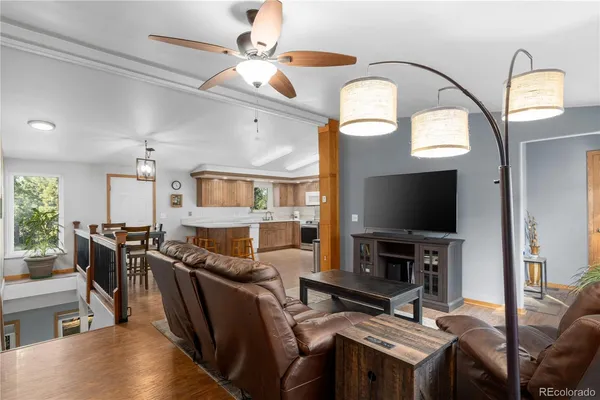 a living room with furniture a flat screen tv and a fireplace