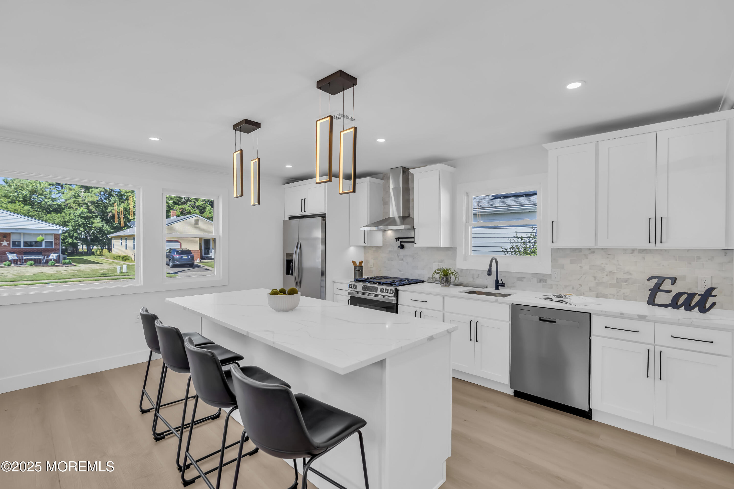143 Davenport Road Toms River, NJ 08757 - Photo 20 of 42 a kitchen with a sink a stove a refrigerator and white cabinets with wooden floor
