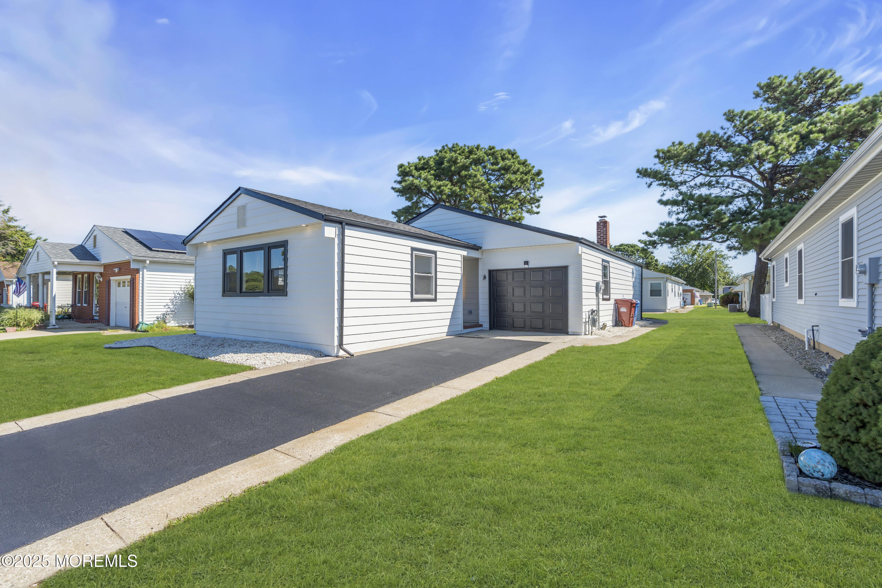 143 Davenport Road Toms River, NJ 08757 - Photo 3 of 42 a front view of a house with a yard and garage