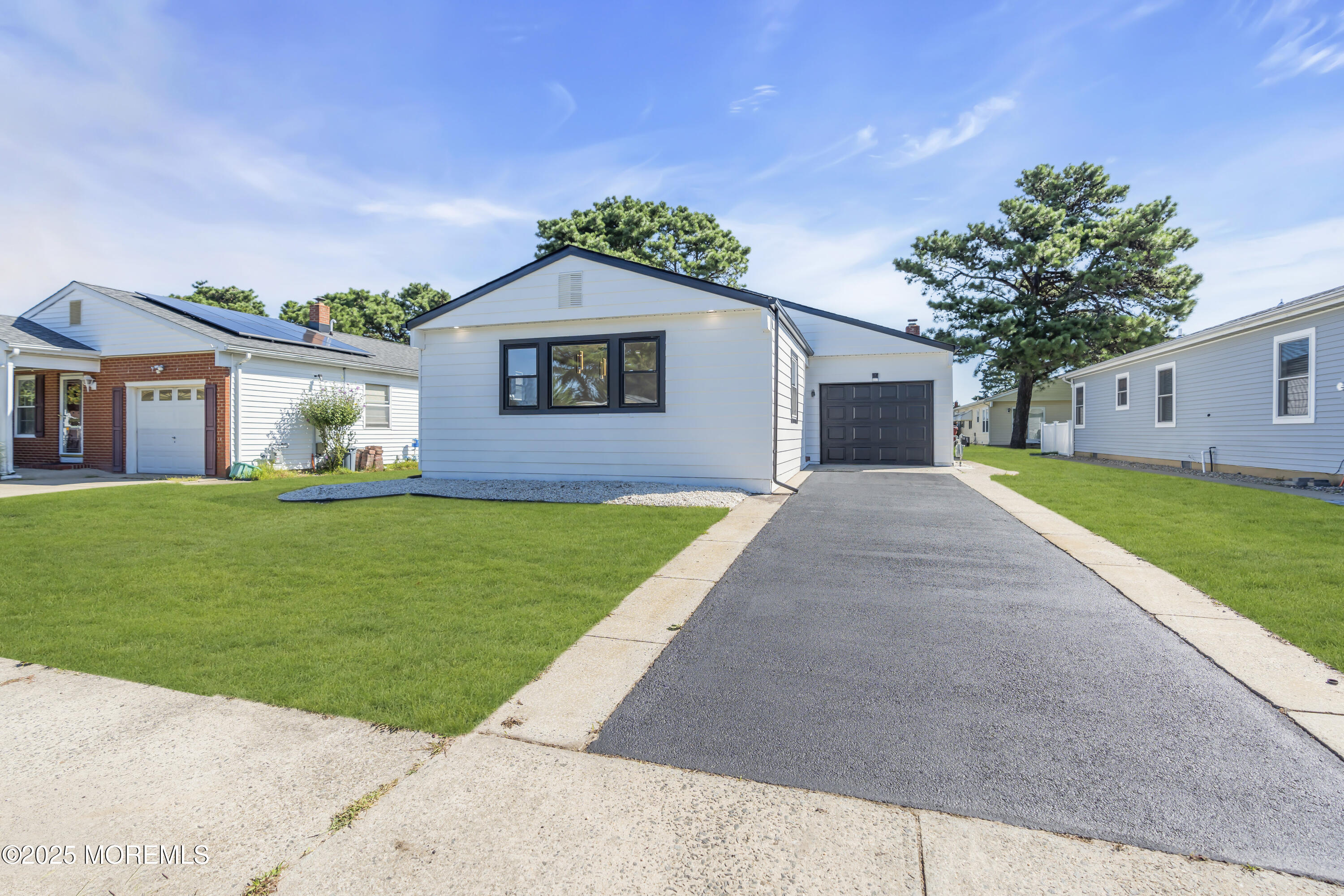 143 Davenport Road Toms River, NJ 08757 - Photo 4 of 42 a front view of a house with a yard and garage