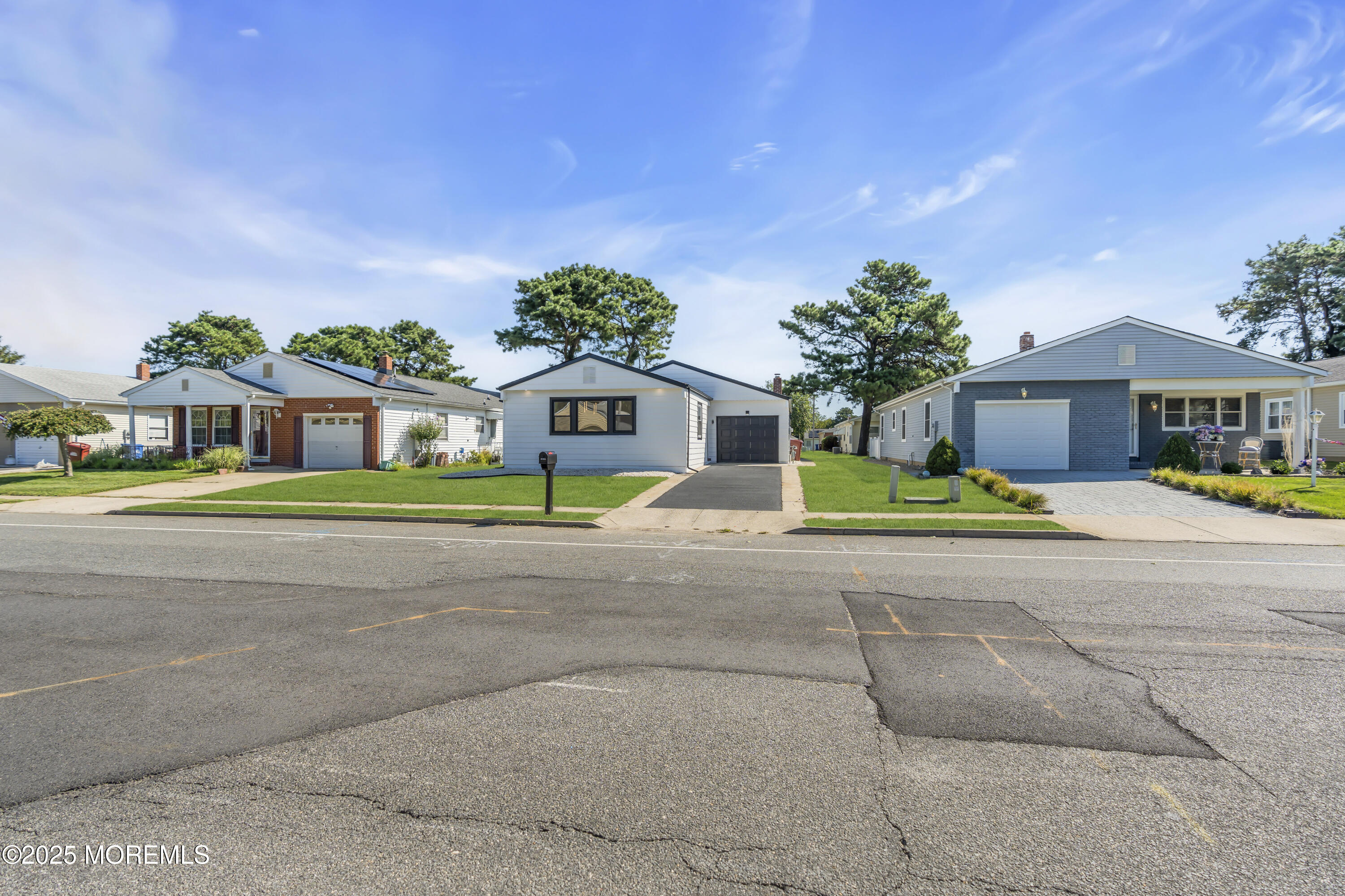 143 Davenport Road Toms River, NJ 08757 - Photo 5 of 42 a front view of a house with a yard and potted plants