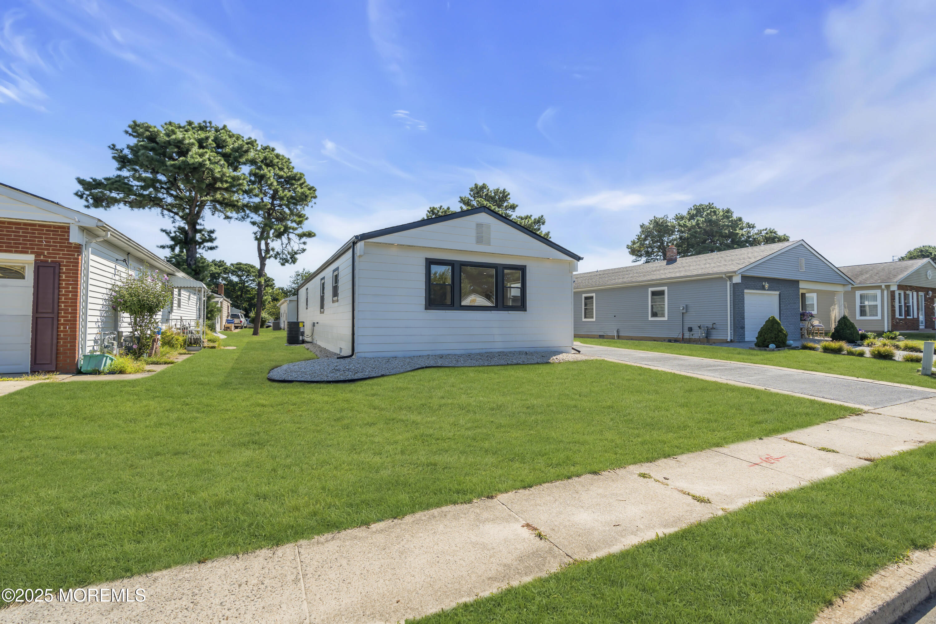 143 Davenport Road Toms River, NJ 08757 - Photo 7 of 42 a front view of a house with a garden
