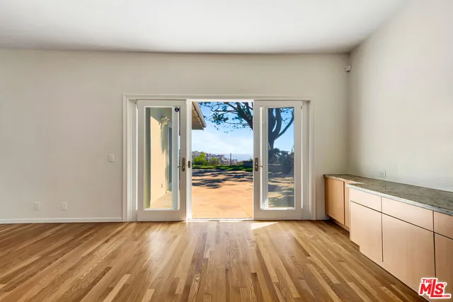 a view of an empty room and glass door