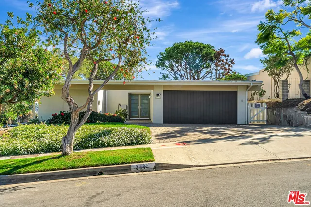 a house with a tree in front of it