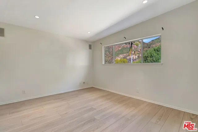 a view of a park with large trees