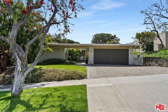 a view of a house with a yard and a garage