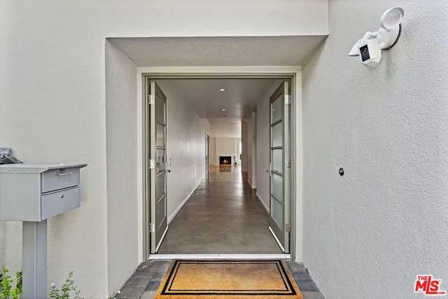 a view of empty room with wooden floor and fireplace