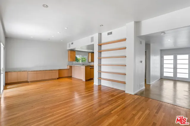 a kitchen with a sink window and cabinets
