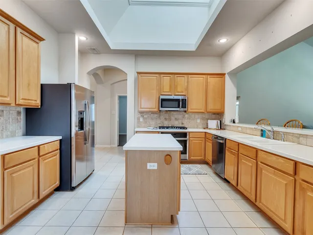 an empty room with wooden floor and fan