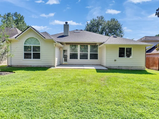 a front view of a house with a yard and green space