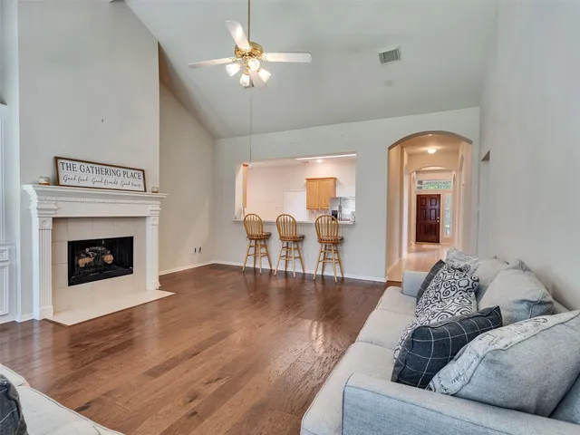 a living room with furniture and a chandelier