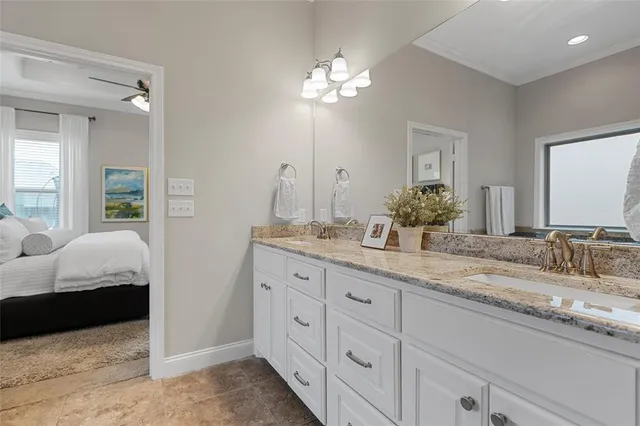 a en suite bathroom with double sink and a mirror