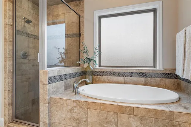 a bathroom with a tub and a shower