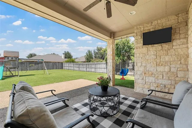 a view of a patio with couches chairs and a big yard
